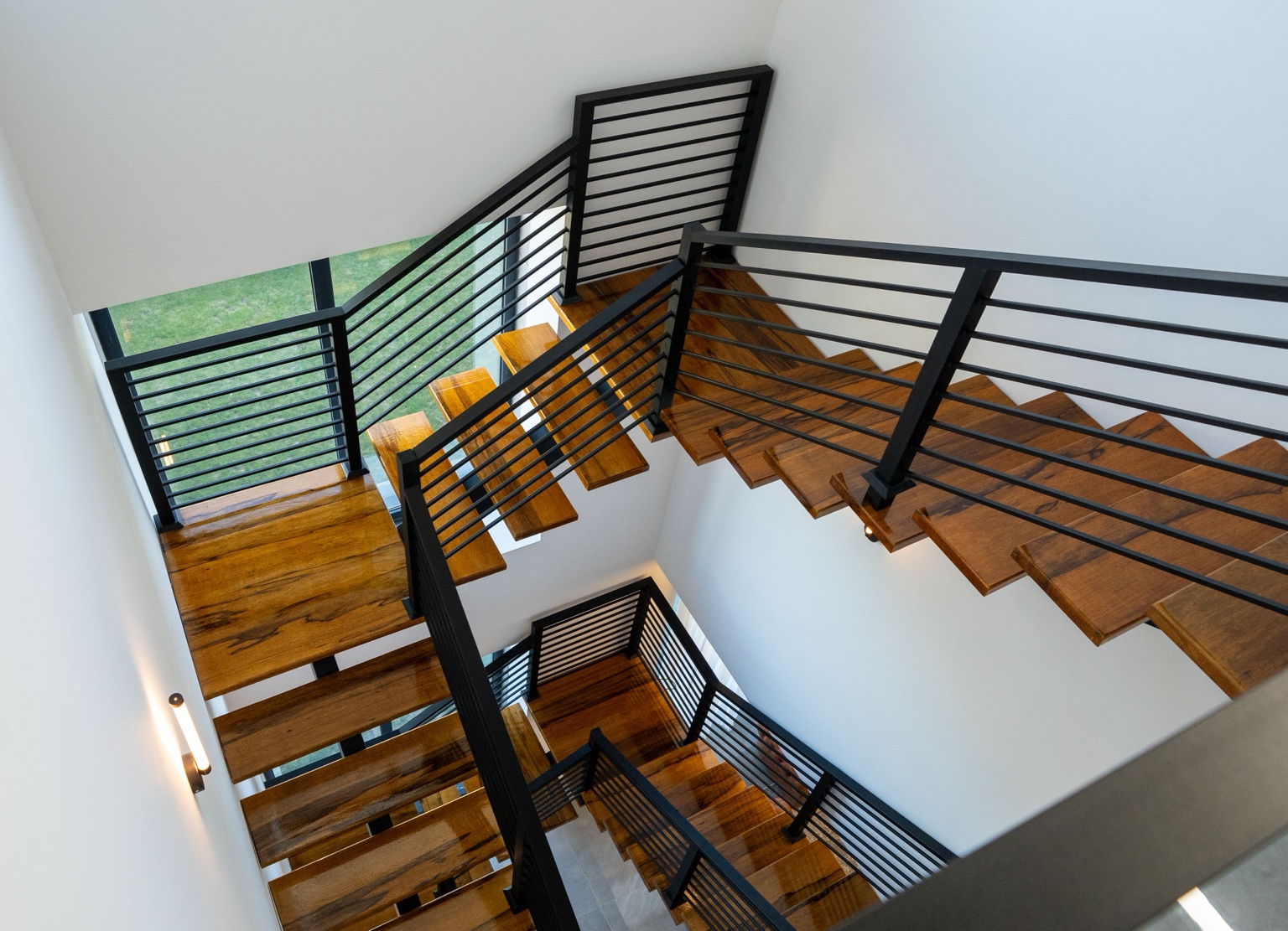 Modern wood staircase with custom black metal railings